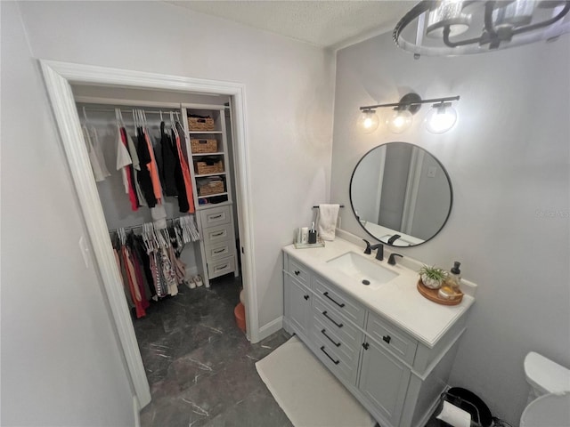 bathroom with vanity and a textured ceiling