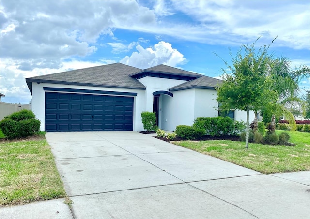 single story home with a garage and a front lawn