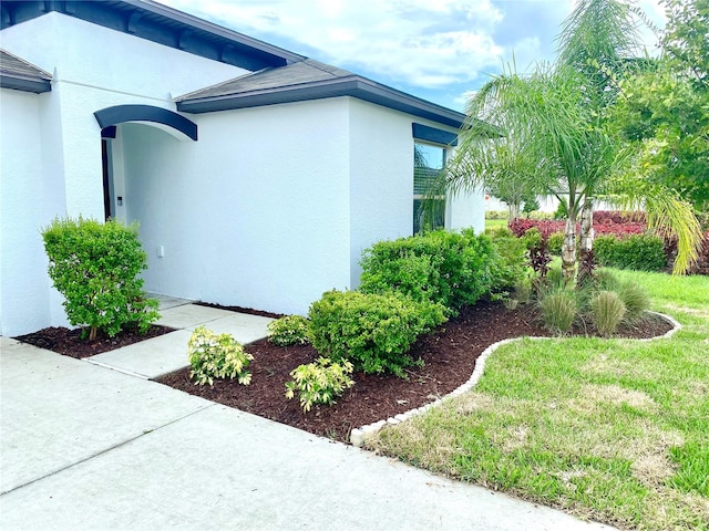 view of property exterior with a lawn