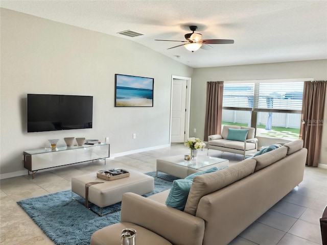 tiled living room with lofted ceiling, a textured ceiling, and ceiling fan