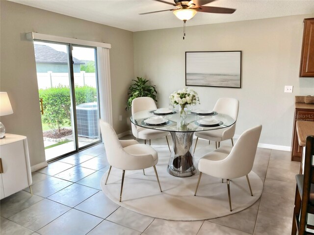 tiled dining space featuring ceiling fan