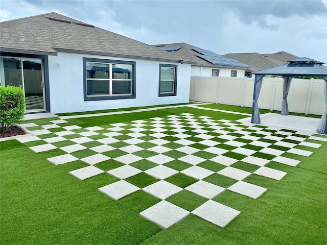 rear view of property with a patio and a lawn