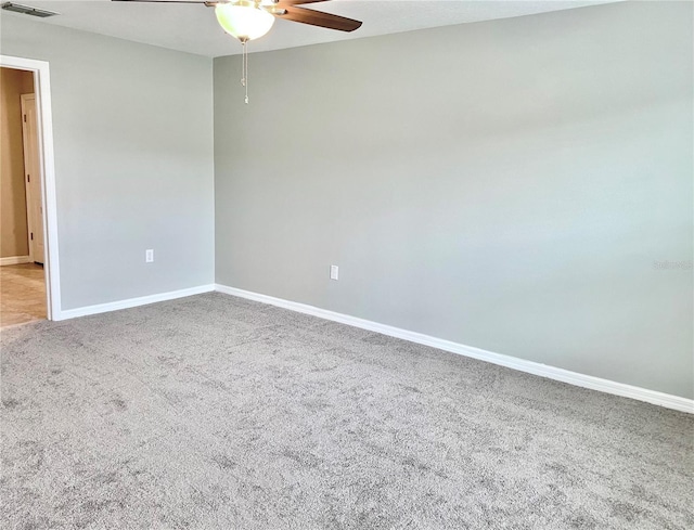 carpeted spare room featuring ceiling fan