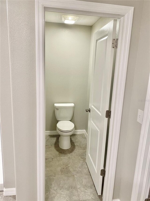 bathroom featuring tile patterned flooring and toilet