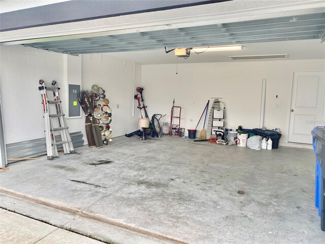 garage featuring electric panel and a garage door opener