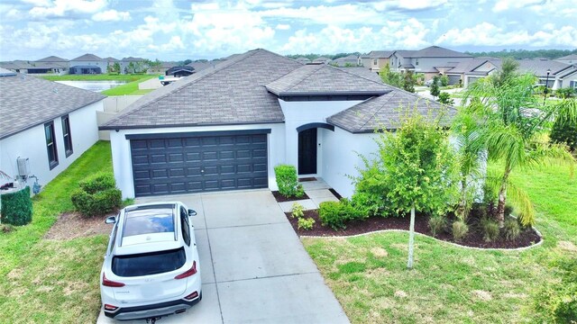 view of front of property featuring a garage and a front yard