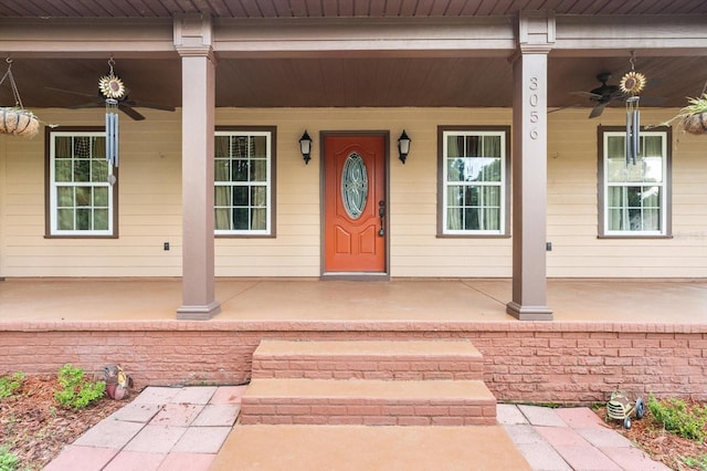 doorway to property featuring ceiling fan and a porch