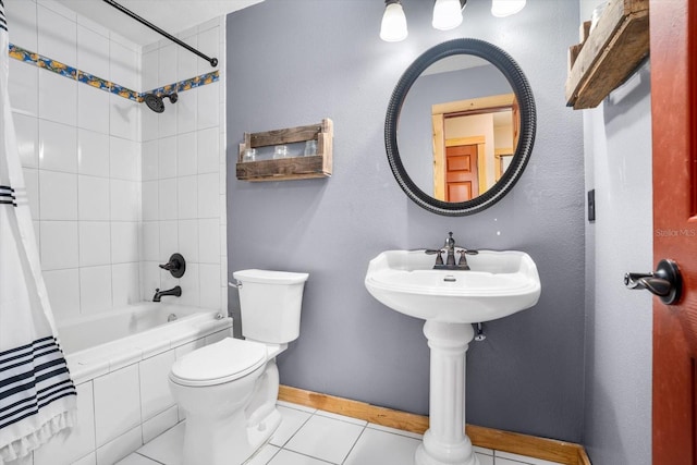 bathroom with shower / bath combo, tile patterned floors, and toilet