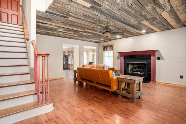 living room with ceiling fan, wood ceiling, and hardwood / wood-style floors