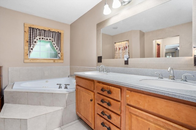 bathroom with tiled tub, tile patterned floors, and vanity