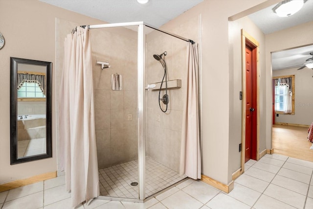 bathroom featuring ceiling fan, tile patterned flooring, and a shower with shower curtain