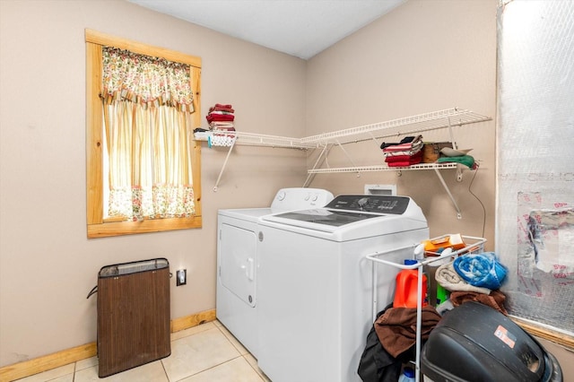 laundry area featuring separate washer and dryer and light tile patterned floors