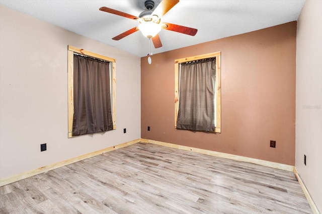 spare room with ceiling fan and light hardwood / wood-style flooring