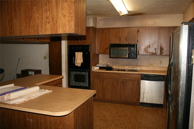 kitchen with tile patterned flooring and black appliances