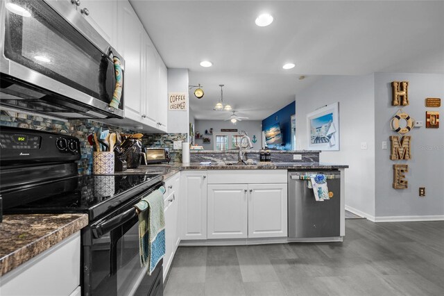 kitchen with white cabinetry, ceiling fan, appliances with stainless steel finishes, kitchen peninsula, and backsplash