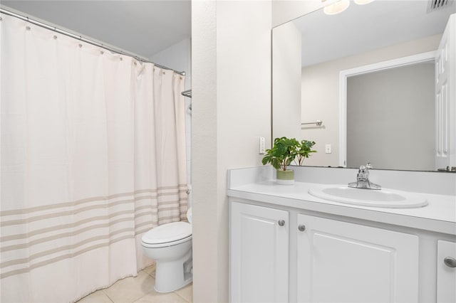 bathroom with tile patterned flooring, vanity, and toilet