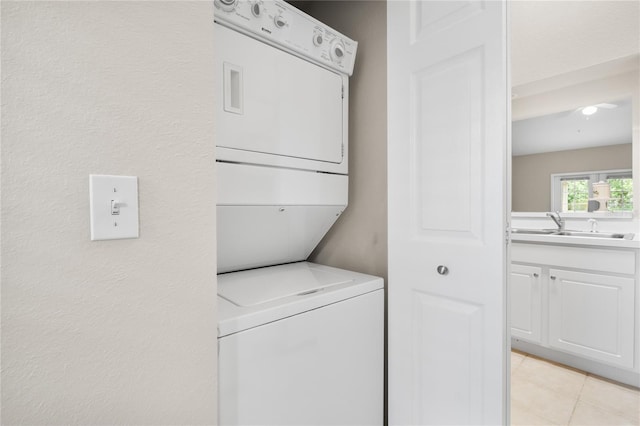 clothes washing area with stacked washer / dryer and sink