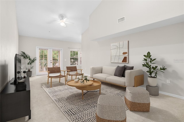 living room with high vaulted ceiling, light carpet, ceiling fan, and french doors