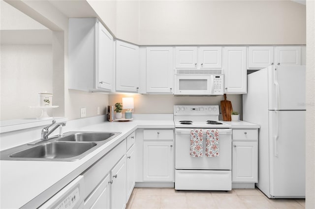 kitchen featuring white cabinetry, white appliances, sink, and light tile patterned floors