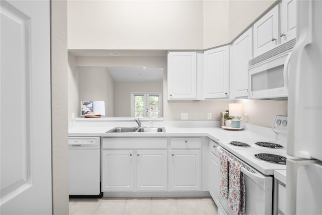 kitchen with white cabinetry, sink, and white appliances