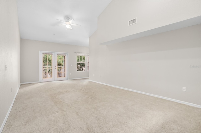 unfurnished room with french doors, ceiling fan, high vaulted ceiling, and light carpet