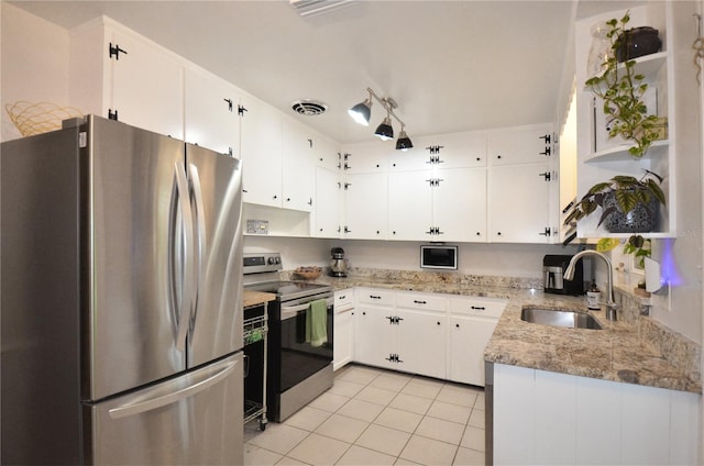 kitchen featuring sink, appliances with stainless steel finishes, light stone counters, and white cabinetry