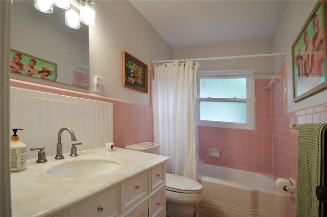 full bathroom with vanity, toilet, shower / bath combo, and tile walls