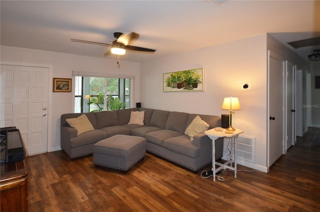 living room featuring dark wood-type flooring and ceiling fan