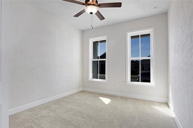 unfurnished room featuring carpet floors, ceiling fan, and baseboards