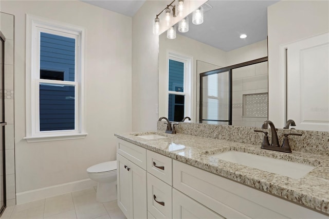 full bath with a stall shower, tile patterned flooring, a sink, and baseboards