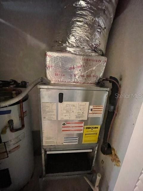 utility room featuring water heater