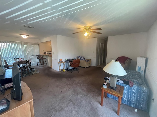 carpeted living room featuring ceiling fan