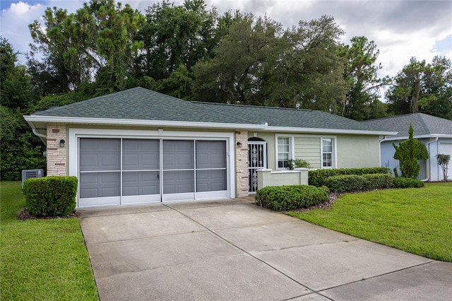 ranch-style home featuring a garage and a front lawn