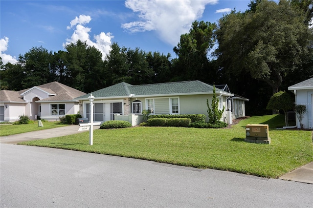 ranch-style house with a garage and a front yard