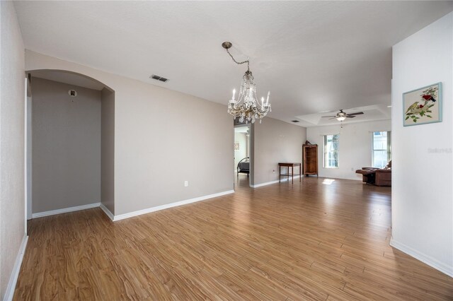 unfurnished living room with light hardwood / wood-style floors and ceiling fan with notable chandelier