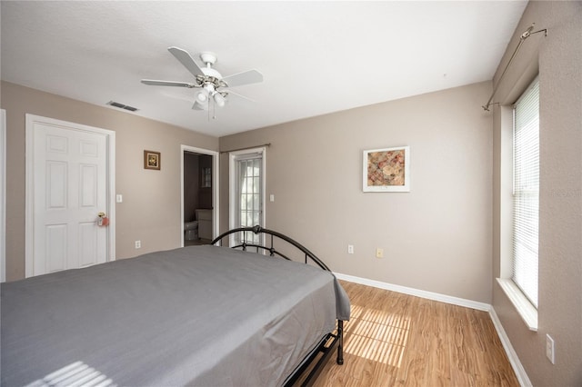 bedroom featuring light hardwood / wood-style floors, multiple windows, and ceiling fan