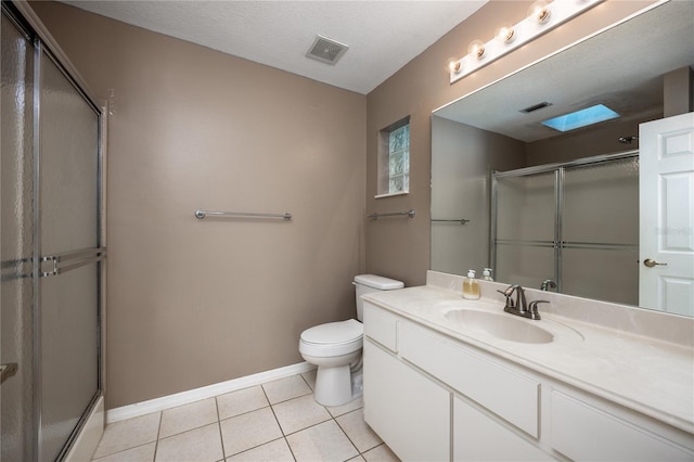 bathroom featuring vanity, an enclosed shower, tile patterned flooring, and toilet