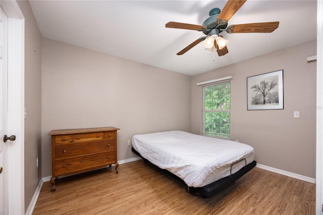 bedroom with light hardwood / wood-style flooring and ceiling fan