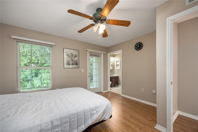 bedroom featuring light hardwood / wood-style floors, ensuite bath, and ceiling fan