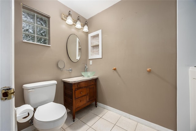 bathroom featuring tile patterned flooring, toilet, and vanity