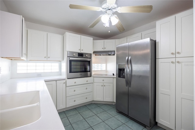 kitchen featuring ceiling fan, white cabinets, and stainless steel appliances