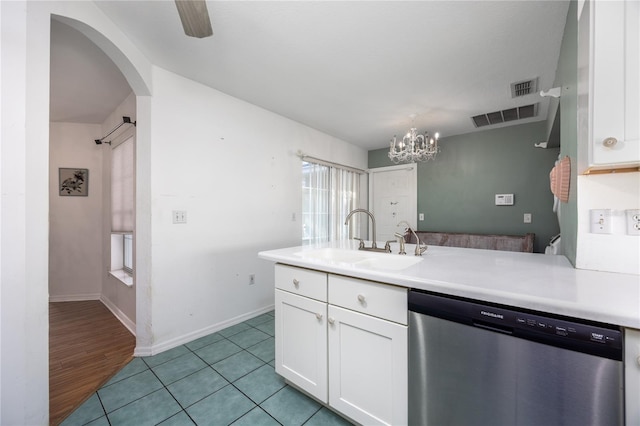 kitchen with sink, light tile patterned floors, white cabinetry, ceiling fan with notable chandelier, and dishwasher