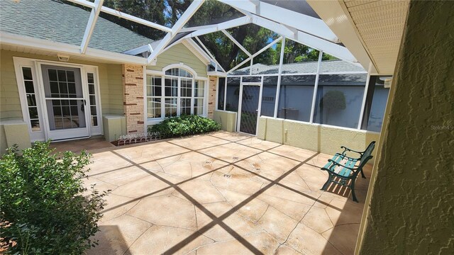 view of patio / terrace featuring a lanai