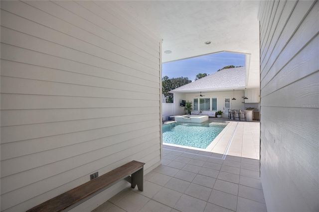 view of pool with an in ground hot tub and a patio area