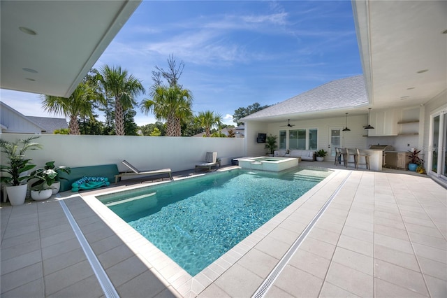 view of pool featuring an in ground hot tub, ceiling fan, and a patio area