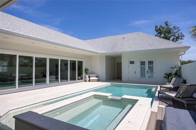 view of swimming pool with a patio and an in ground hot tub