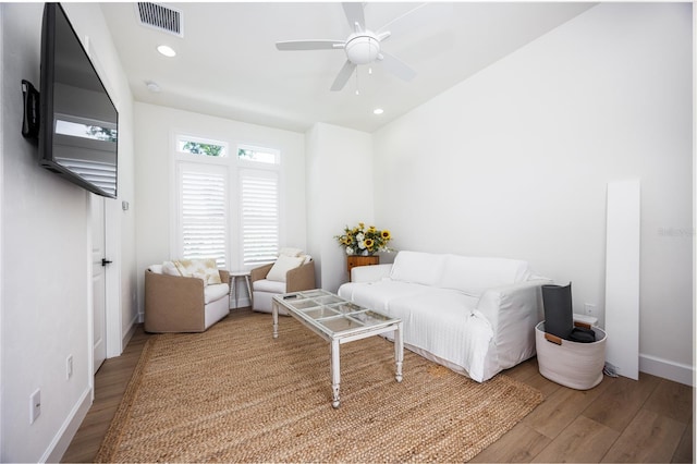 living room featuring light wood-type flooring and ceiling fan