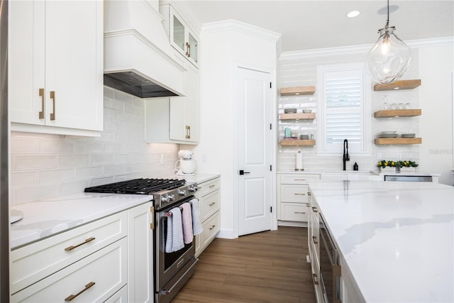 kitchen featuring premium range hood, decorative light fixtures, gas range, decorative backsplash, and dark hardwood / wood-style flooring