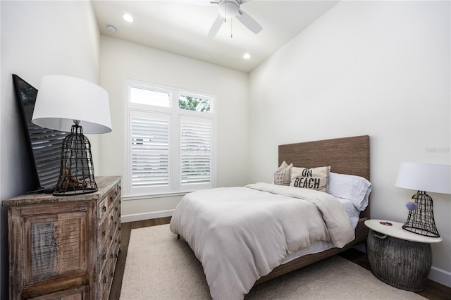 bedroom featuring hardwood / wood-style flooring, lofted ceiling, and ceiling fan