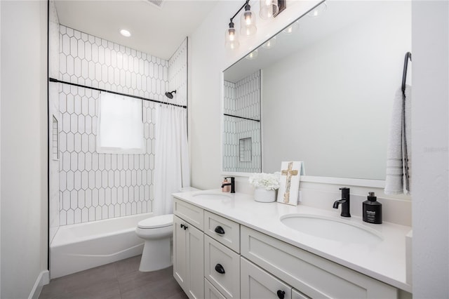 full bathroom with tile patterned floors, double vanity, shower / bath combo with shower curtain, and toilet